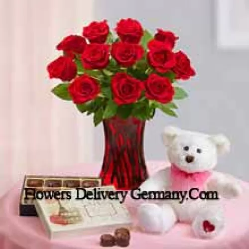 11 Red Roses With Some Ferns In A Glass Vase, A Cute 12 Inches Tall White Teddy Bear And An Imported Box Of Chocolates