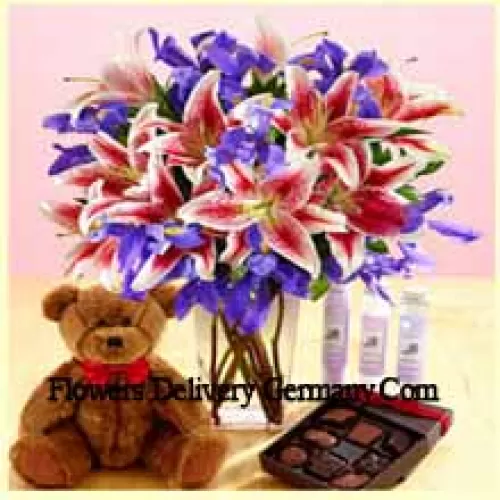 Pink Lilies And Assorted Purple Flowers Arranged Beautifully In A Glass Vase, A Cute 12 Inches Tall Brown Teddy Bear And An Imported Box Of Chocolates