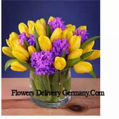 Yellow Tulips Arranged Beautifully In A Glass Vase - Please Note That In Case Of Non-Availability Of Certain Seasonal Flowers The Same Will Be Substituted With Other Flowers Of Same Value