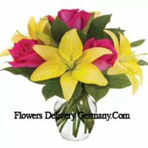Pink Roses And Yellow Lilies With Seasonal Fillers Arranged Beautifully In A Glass Vase