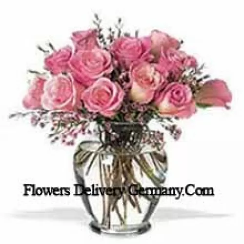 Mazzo di 11 rose rosa con alcune felci in un vaso