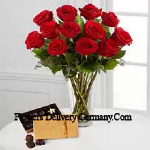 11 Red Roses With Some Ferns In A Vase And A Box Of Godiva Chocolates (We reserve the right to substitute the Godiva chocolates with chocolates of equal value in case of non-availability of the same. Limited Stock)